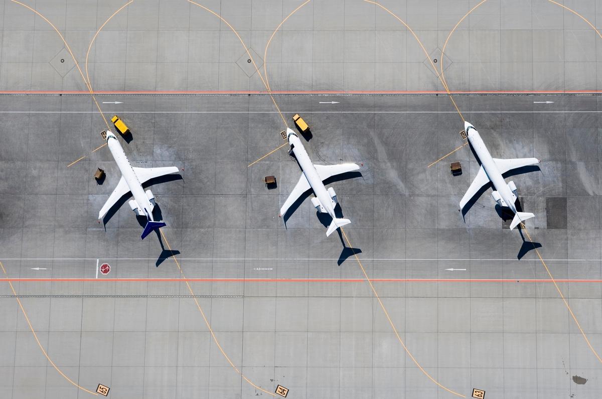 Three planes on tarmac birds eye